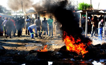 Striking miners erect burning barricades.            Photo: SAPA stringer 