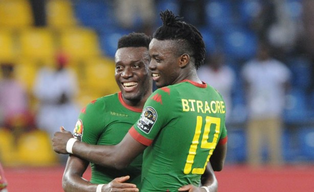 Alain Traore, left, who scored with a superb free-kick to seal the bronze medal for the Burkinabe, celebrates with his brother, Bertrand (no. 19).